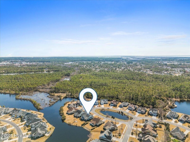 drone / aerial view with a water view and a view of trees