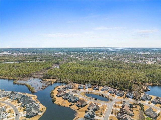 bird's eye view featuring a water view and a wooded view