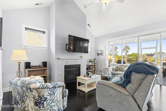 living room featuring dark wood-style floors, a fireplace, visible vents, and baseboards