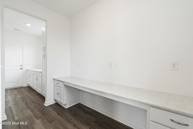 interior space featuring dark wood-style floors and built in study area