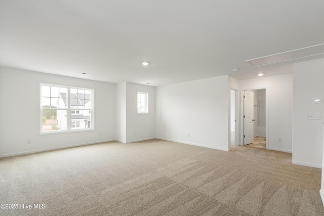 unfurnished room with light carpet, recessed lighting, and baseboards