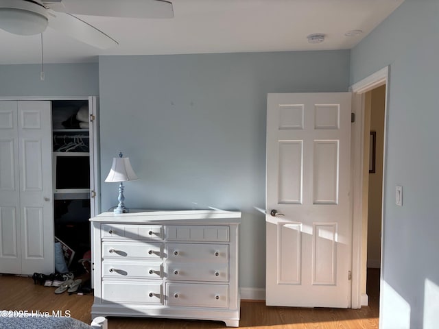 bedroom with a closet, ceiling fan, and wood finished floors