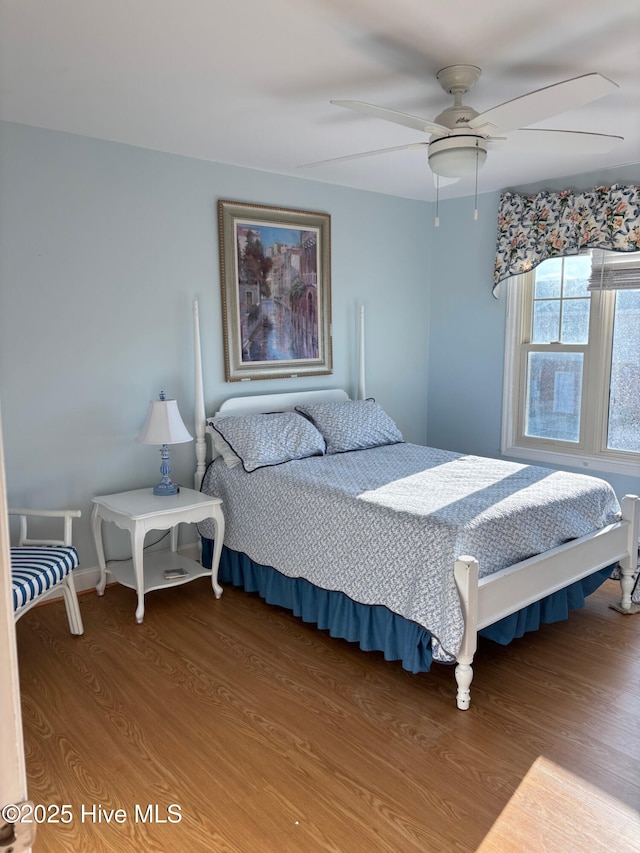 bedroom with ceiling fan and wood finished floors