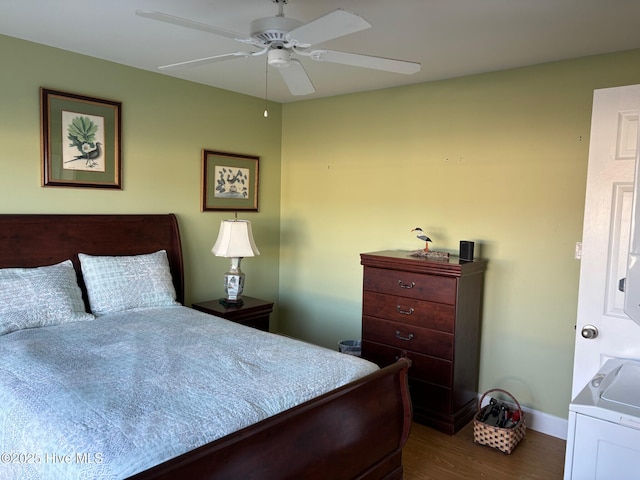 bedroom with dark wood-style floors, ceiling fan, washer / dryer, and baseboards