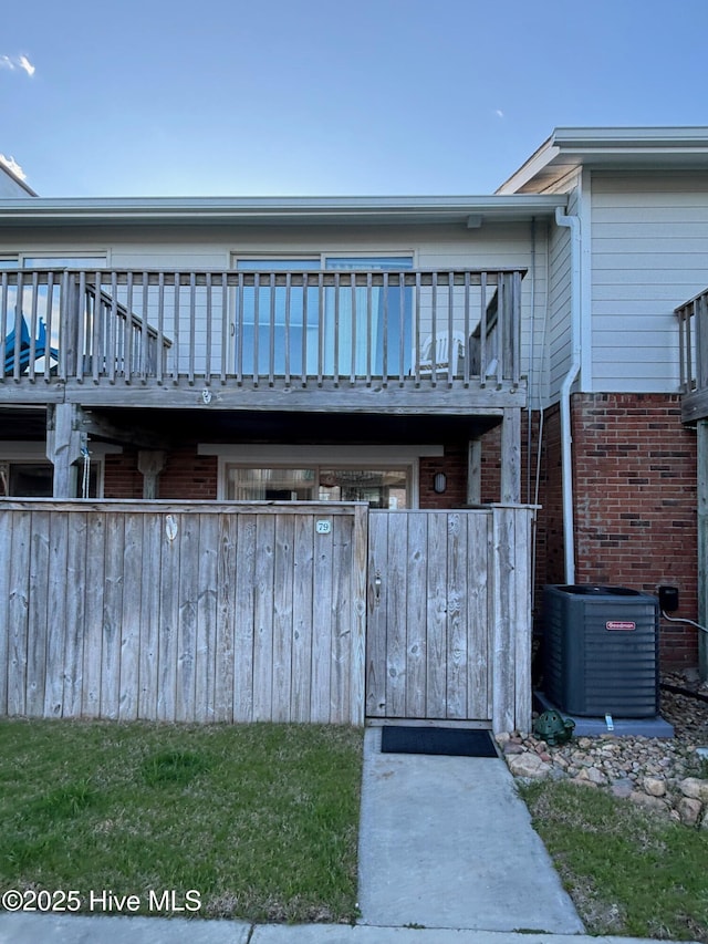 exterior space with brick siding and central AC unit