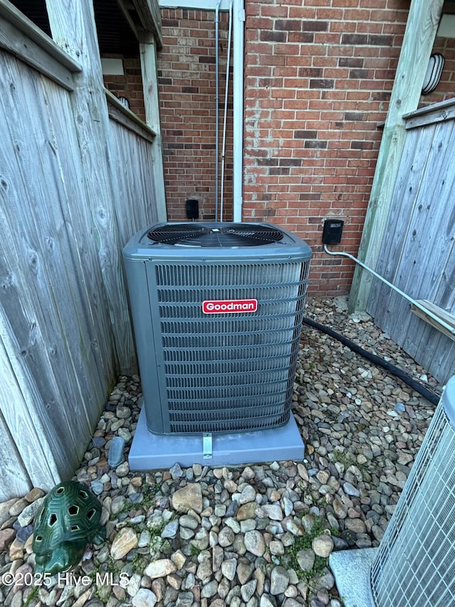 exterior details featuring brick siding and central air condition unit