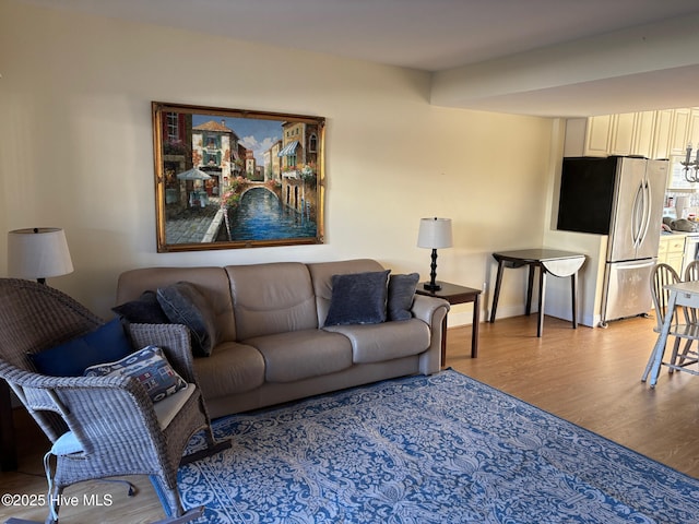 living room with baseboards and wood finished floors