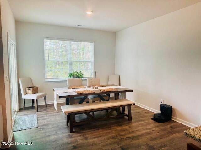 dining room featuring baseboards and wood finished floors