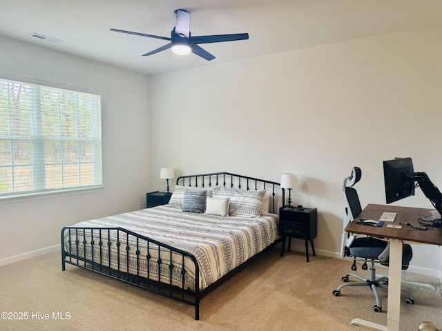 carpeted bedroom featuring visible vents, ceiling fan, and baseboards