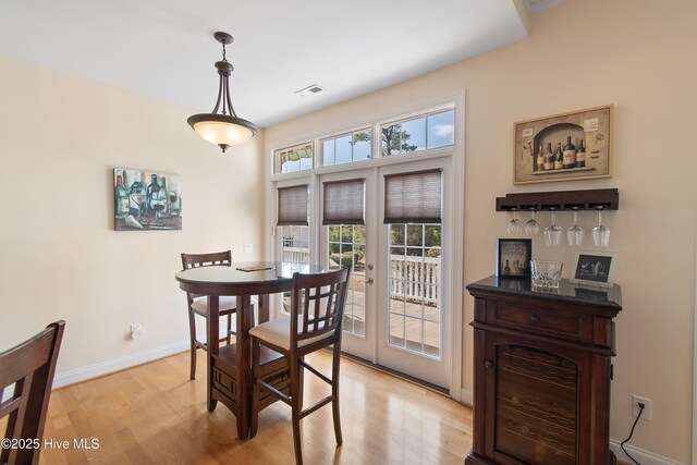 2906 Legends Dr, Southport, NC 28461 - dining area featuring light wood-style flooring and a dry bar