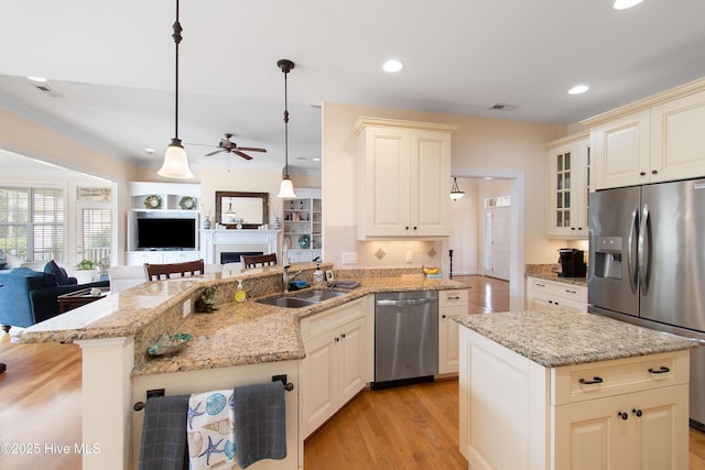 2906 Legends Dr, Southport, NC 28461 - kitchen featuring appliances with stainless steel finishes, open floor plan, ceiling fan, a peninsula, and recessed lighting