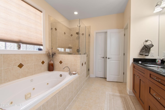 2906 Legends Dr, Southport, NC 28461 - bathroom with a whirlpool tub, a stall shower, vanity, and tile patterned floors