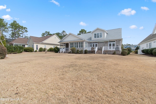 2906 Legends Dr, Southport, NC 28461 - view of front of house with covered porch and french doors