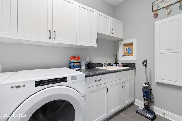 2906 Legends Dr, Southport, NC 28461 - laundry area featuring cabinet space, washing machine and clothes dryer, and dark tile patterned floors
