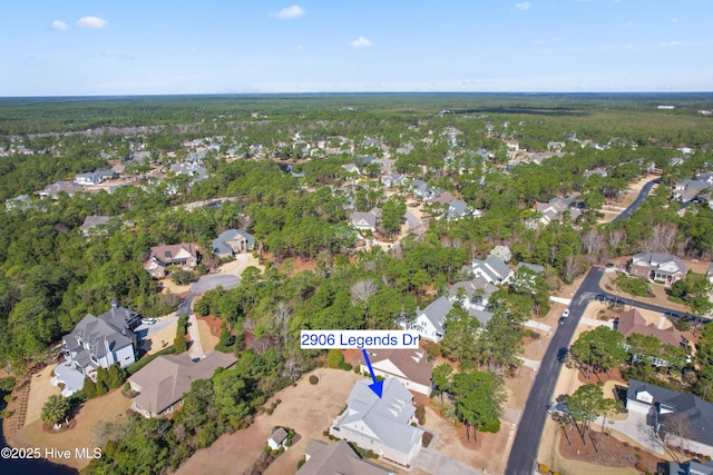 2906 Legends Dr, Southport, NC 28461 - aerial overview of property's location featuring nearby suburban area and a heavily wooded area