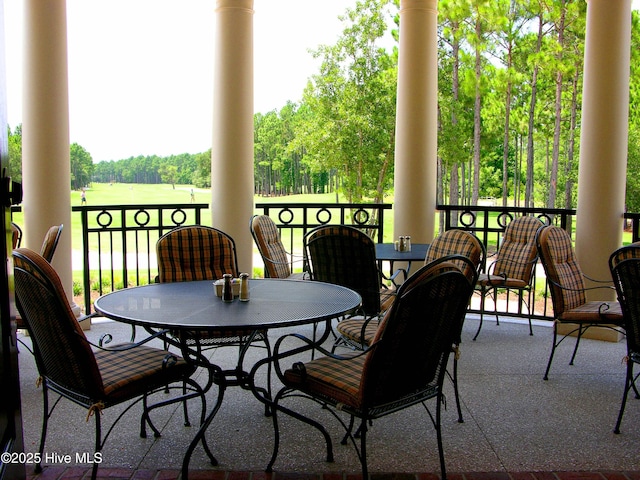 2906 Legends Dr, Southport, NC 28461 - view of patio featuring outdoor dining space and view of scattered trees