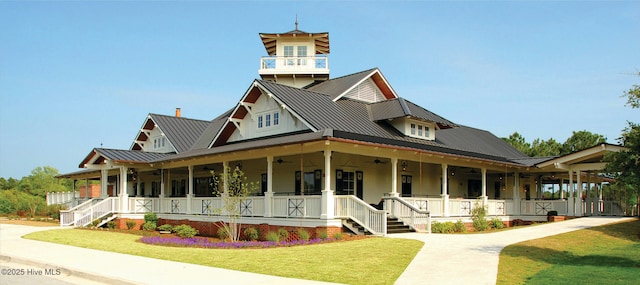 2906 Legends Dr, Southport, NC 28461 - view of front of home with ceiling fan, covered porch, a front yard, and a metal roof