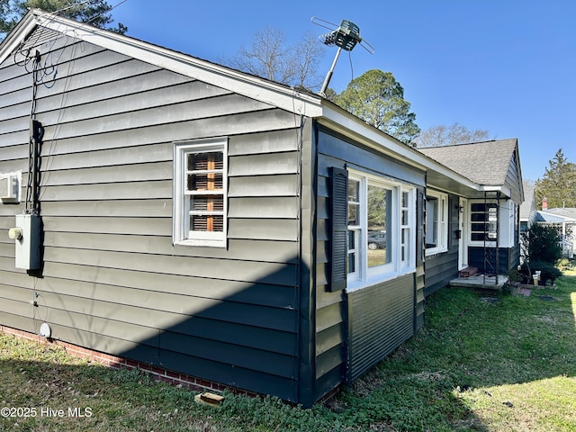 view of side of home featuring a yard