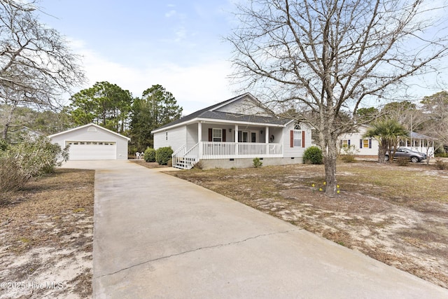 bungalow-style home with crawl space, a detached garage, a porch, and an outbuilding