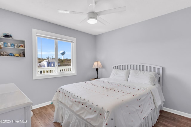 bedroom featuring a ceiling fan, wood finished floors, and baseboards