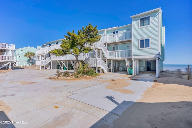 exterior space featuring stairs, a carport, and driveway