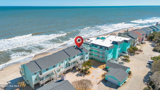 birds eye view of property with a beach view and a water view