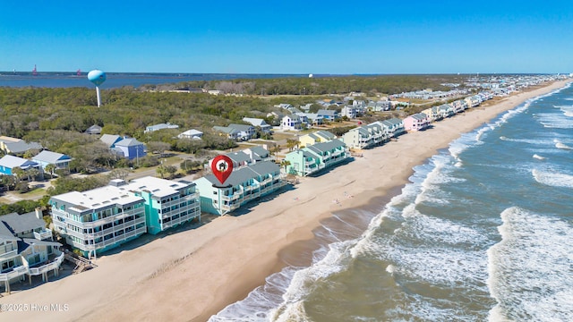 drone / aerial view with a beach view and a water view