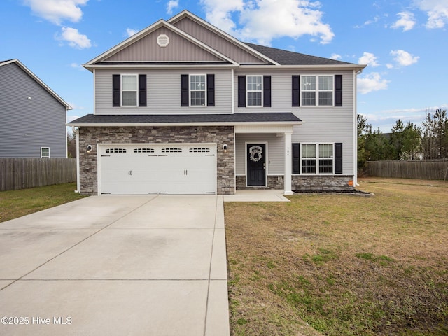 view of front of property with an attached garage, fence, driveway, and a front lawn