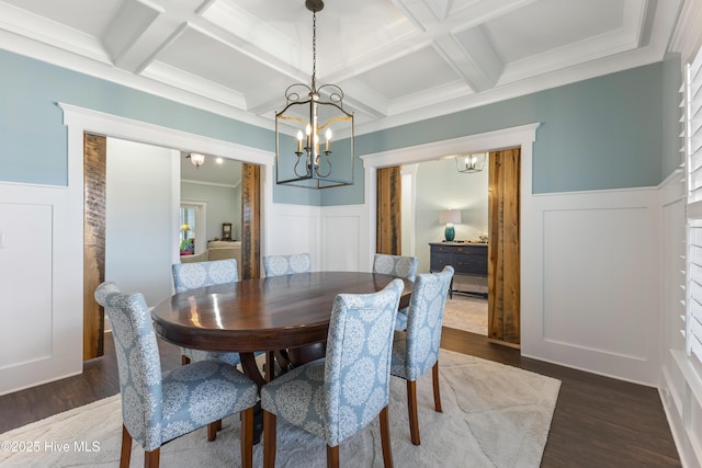 dining area featuring beamed ceiling, dark wood-style flooring, coffered ceiling, and a chandelier