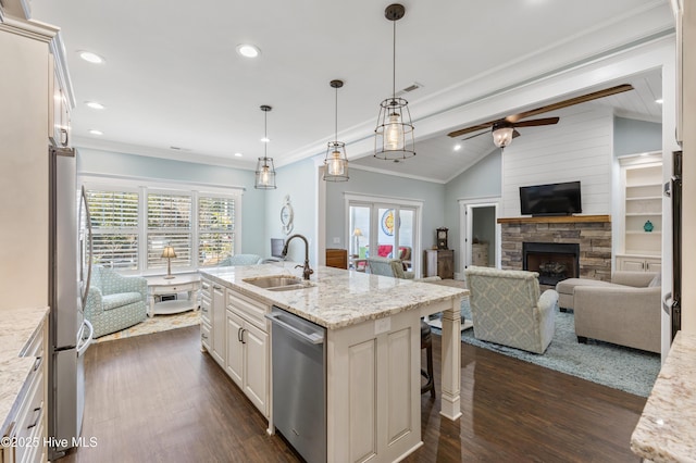 kitchen featuring vaulted ceiling with beams, open floor plan, appliances with stainless steel finishes, dark wood-style floors, and a sink