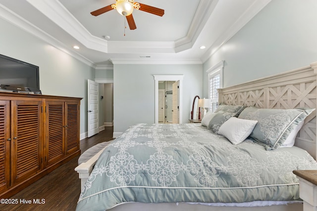 bedroom with a tray ceiling, crown molding, recessed lighting, and wood finished floors