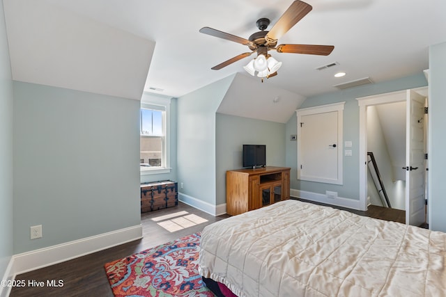 bedroom with visible vents, baseboards, lofted ceiling, and wood finished floors