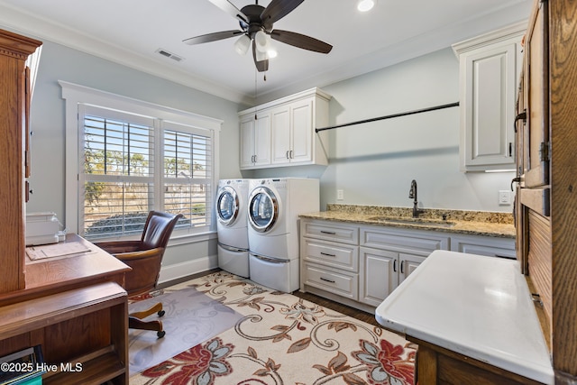 laundry area with a ceiling fan, visible vents, cabinet space, ornamental molding, and a sink