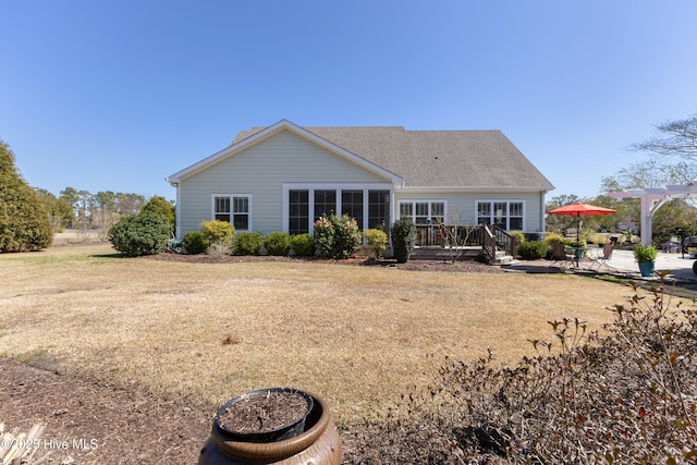 rear view of property featuring a patio area, roof with shingles, a deck, and a pergola