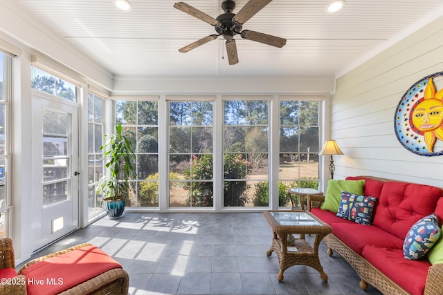 sunroom / solarium featuring ceiling fan