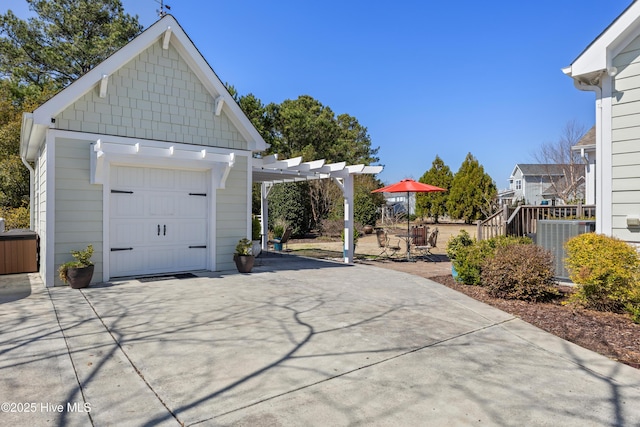 view of side of property featuring a garage, cooling unit, and a pergola