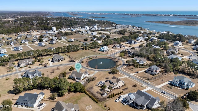 drone / aerial view featuring a residential view and a water view