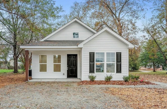 view of front of home with a porch and a shingled roof