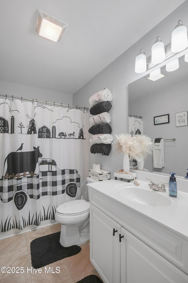 bathroom featuring tile patterned floors, visible vents, toilet, and vanity