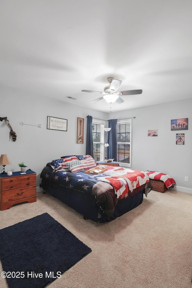 bedroom featuring visible vents, carpet floors, and ceiling fan