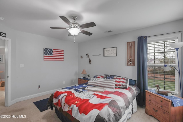 bedroom featuring a ceiling fan, light colored carpet, visible vents, and baseboards