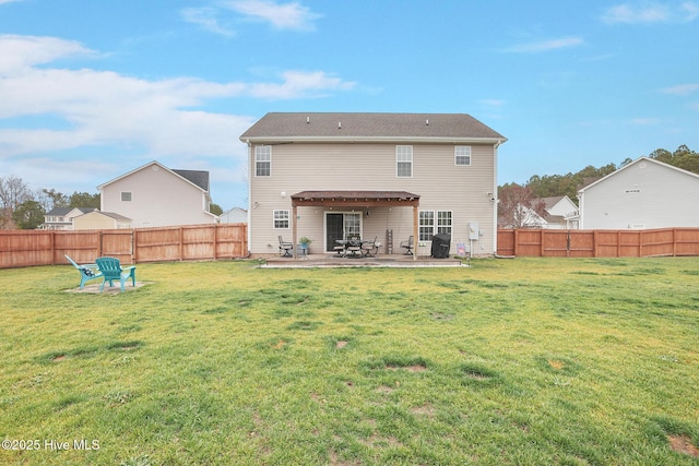 back of property featuring a yard, a fenced backyard, and a patio