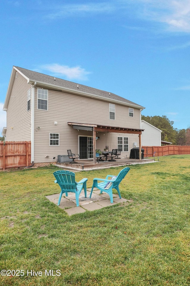 back of property featuring a patio area, a lawn, and a fenced backyard