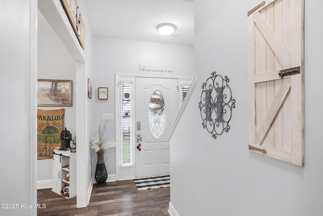 foyer featuring dark wood-type flooring and baseboards