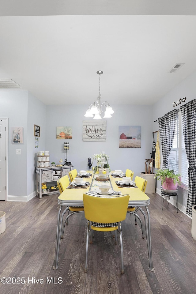 dining area with an inviting chandelier, wood finished floors, baseboards, and visible vents