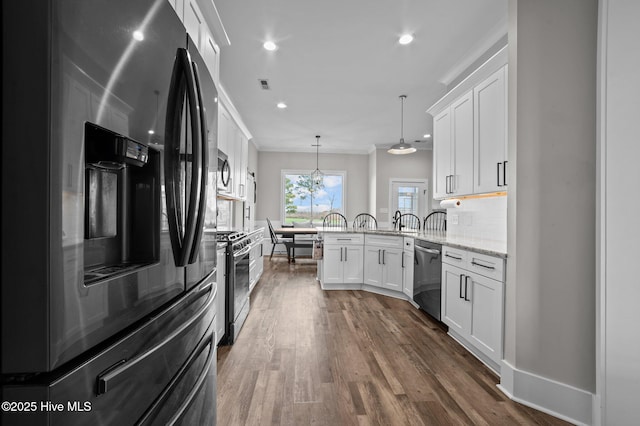 kitchen featuring crown molding, a peninsula, appliances with stainless steel finishes, and white cabinets