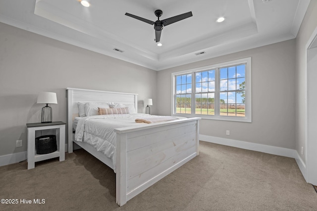 bedroom with carpet, a raised ceiling, and baseboards