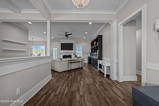 living room with dark wood-style floors, a fireplace, ornamental molding, and recessed lighting