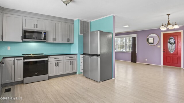 13596 Hobbton Hwy, Newton Grove, NC 28366 - kitchen with stainless steel appliances, gray cabinets, light wood-style floors, a chandelier, and crown molding