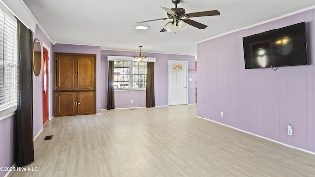 13596 Hobbton Hwy, Newton Grove, NC 28366 - unfurnished living room with ornamental molding, light wood finished floors, a ceiling fan, a chandelier, and baseboards